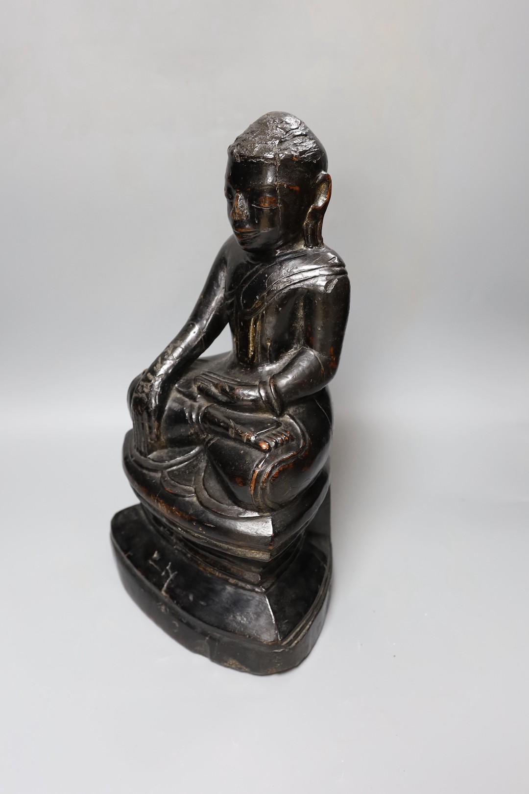 An 18th/19th century Burmese lacquered wood seated figure of Buddha Shakyamuni, 40cm